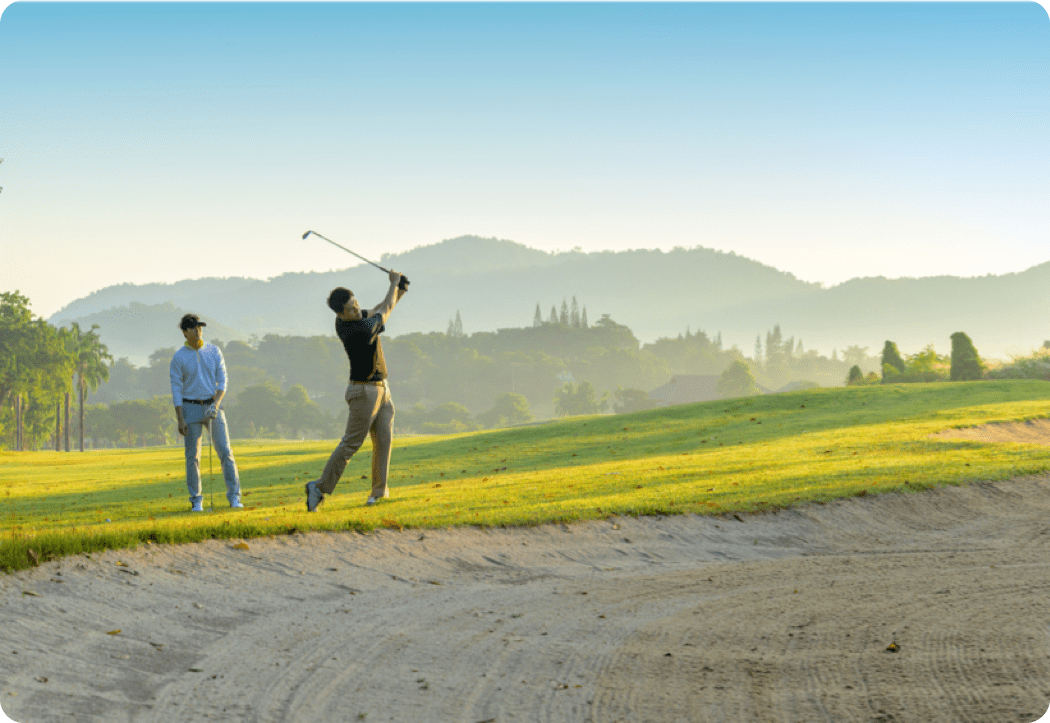 pair of golfers outside of mountain landscape